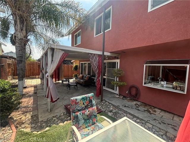 116 Evergreen Pl, Perris, CA 92571 - back of house featuring an outdoor hangout area, a patio, a fenced backyard, and stucco siding