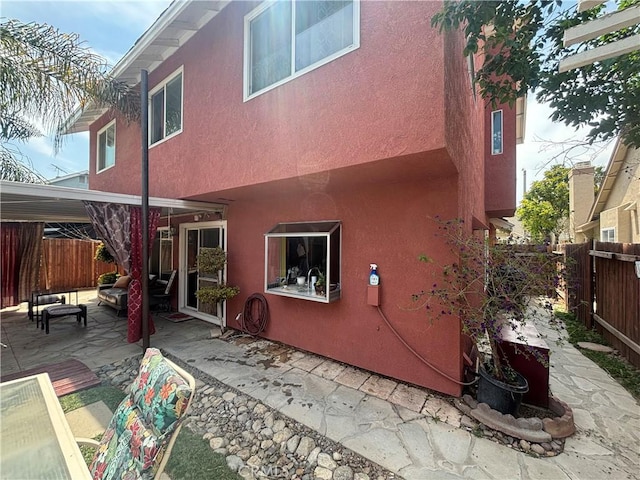 116 Evergreen Pl, Perris, CA 92571 - back of house with stucco siding, a fenced backyard, a patio, and an outdoor hangout area