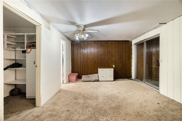 5048 Big Bend Rd, Oroville, CA 95965 - unfurnished bedroom with carpet floors, wooden walls, and a ceiling fan