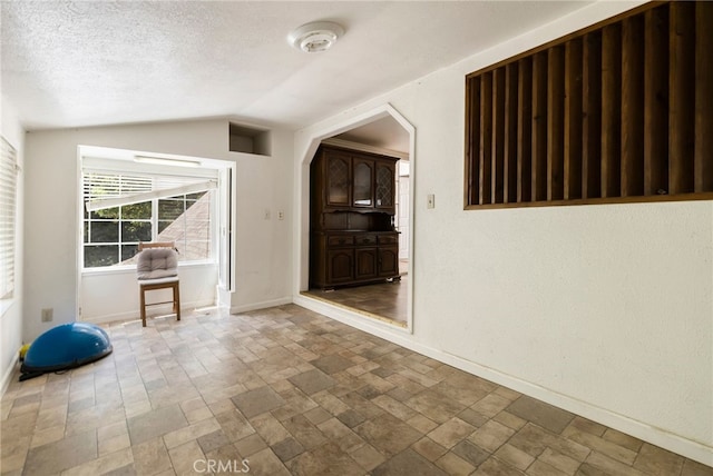 5048 Big Bend Rd, Oroville, CA 95965 - unfurnished room with lofted ceiling, baseboards, and a textured ceiling