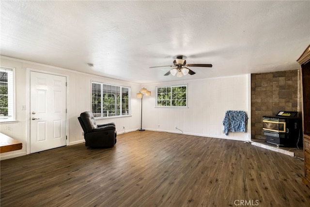 5048 Big Bend Rd, Oroville, CA 95965 - unfurnished room featuring dark wood-style floors, ceiling fan, a wood stove, and baseboards