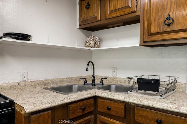 5048 Big Bend Rd, Oroville, CA 95965 - kitchen featuring open shelves, light countertops, a sink, black electric range, and brown cabinets