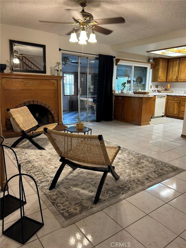 2035 N Spruce Ave, Rialto, CA 92377 - living area with a textured ceiling, a ceiling fan, a fireplace, and light tile patterned flooring