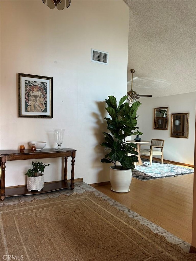 2035 N Spruce Ave, Rialto, CA 92377 - detailed view of a textured ceiling, ceiling fan, wood finished floors, and baseboards