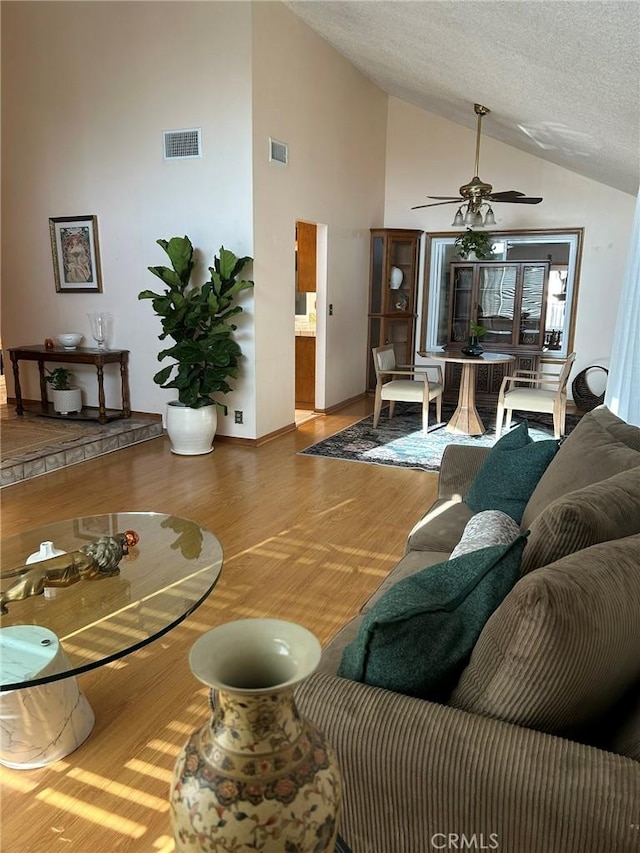 2035 N Spruce Ave, Rialto, CA 92377 - living room with wood finished floors, ceiling fan, high vaulted ceiling, and baseboards