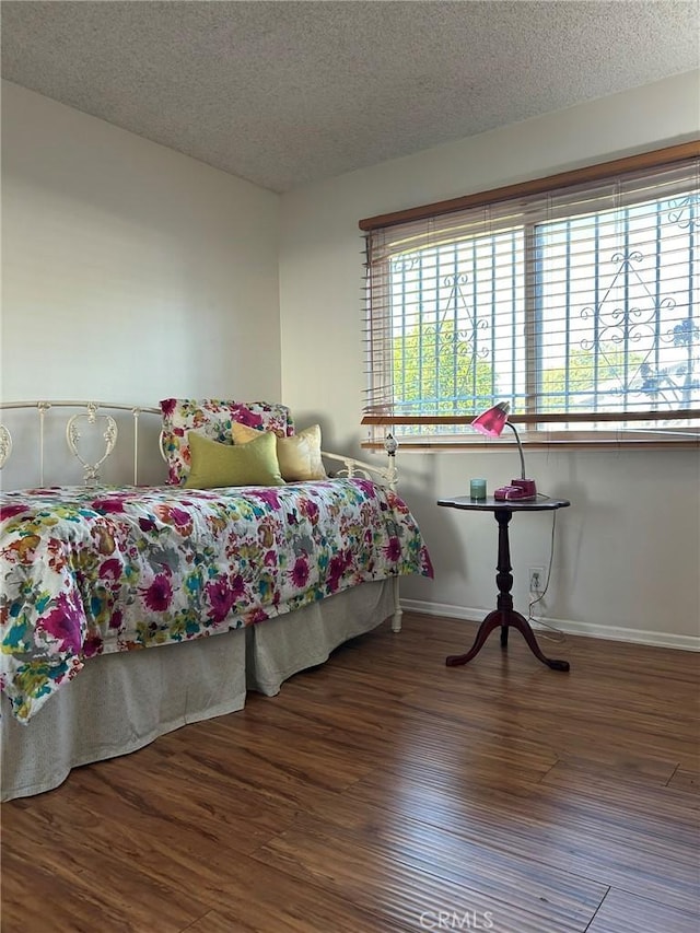 2035 N Spruce Ave, Rialto, CA 92377 - bedroom featuring a textured ceiling, wood finished floors, and baseboards