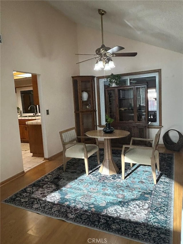 2035 N Spruce Ave, Rialto, CA 92377 - dining room featuring vaulted ceiling, ceiling fan, light wood-type flooring, and baseboards