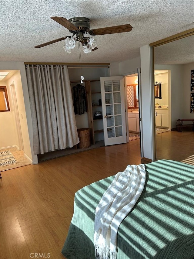 2035 N Spruce Ave, Rialto, CA 92377 - bedroom with a textured ceiling, wood finished floors, and a ceiling fan