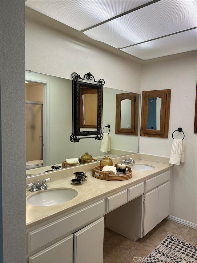 2035 N Spruce Ave, Rialto, CA 92377 - bathroom featuring a shower stall, double vanity, tile patterned flooring, and toilet