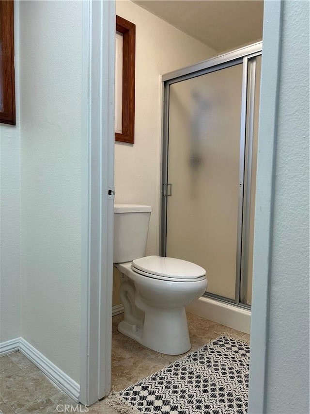 2035 N Spruce Ave, Rialto, CA 92377 - bathroom featuring toilet, a shower stall, and baseboards