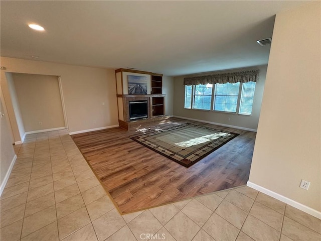1061 Mountain View Dr, Hemet, CA 92545 - unfurnished living room featuring tile patterned flooring, baseboards, a fireplace with raised hearth, and recessed lighting