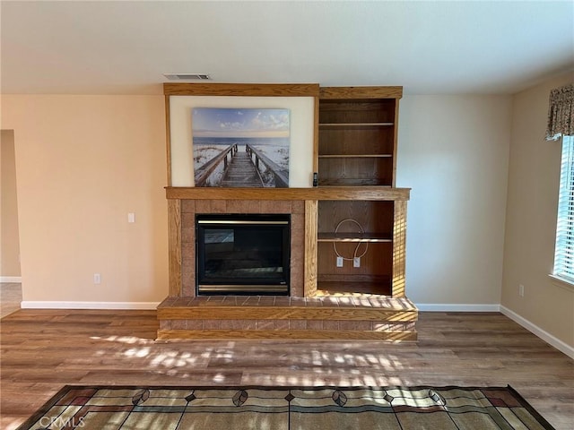 1061 Mountain View Dr, Hemet, CA 92545 - detailed view of a tile fireplace, wood finished floors, and baseboards