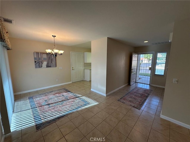 1061 Mountain View Dr, Hemet, CA 92545 - empty room featuring a chandelier, light tile patterned floors, and baseboards