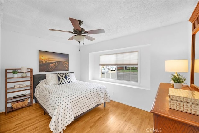 8381 E Hendrie St, Long Beach, CA 90808 - bedroom with light wood-style flooring, a textured ceiling, baseboards, and ceiling fan