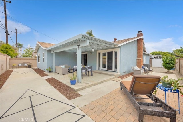 8381 E Hendrie St, Long Beach, CA 90808 - rear view of house with stucco siding, an outdoor living space, a chimney, a fenced backyard, and a patio area