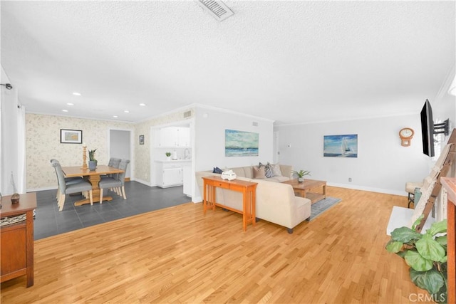 8381 E Hendrie St, Long Beach, CA 90808 - living room with wood finished floors, a textured ceiling, baseboards, and wallpapered walls