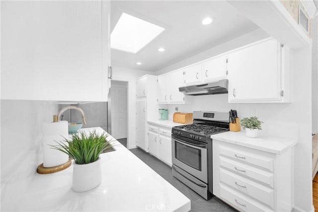 8381 E Hendrie St, Long Beach, CA 90808 - kitchen featuring under cabinet range hood, gas stove, white cabinets, a skylight, and light countertops