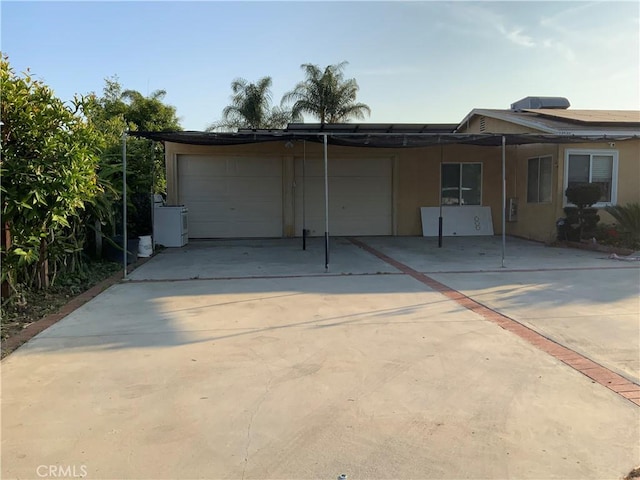 12536 Fineview St, El Monte, CA 91732 - back of house featuring a garage, driveway, and stucco siding