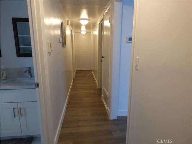 38565 Malby Ave, Palmdale, CA 93550 - hallway with dark wood finished floors, a sink, and baseboards