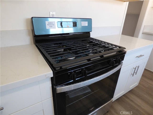 38565 Malby Ave, Palmdale, CA 93550 - kitchen view of stainless steel gas stove, white cabinets, and dark wood-style floors
