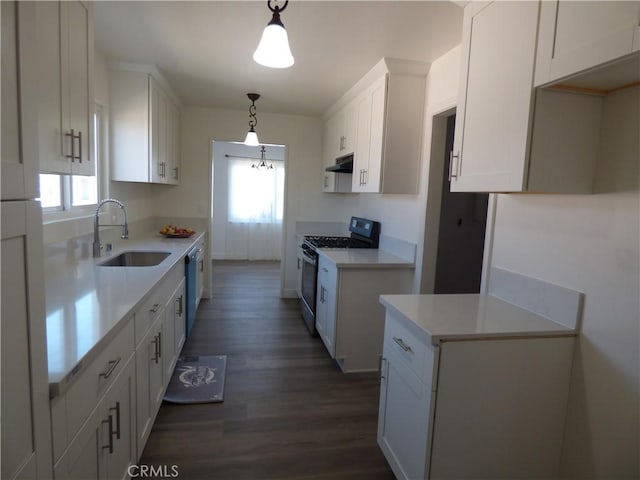 38565 Malby Ave, Palmdale, CA 93550 - kitchen with gas range, a sink, dark wood-style floors, under cabinet range hood, and white cabinetry