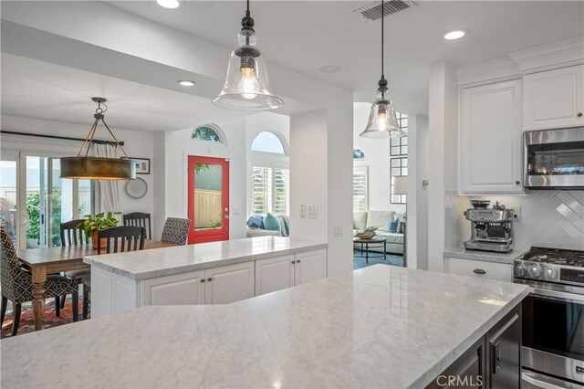 28332 Via Alfonse, Laguna Niguel, CA 92677 - kitchen featuring stainless steel appliances, white cabinetry, backsplash, light stone counters, and recessed lighting