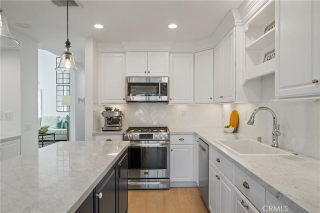 28332 Via Alfonse, Laguna Niguel, CA 92677 - kitchen with stainless steel appliances, a sink, open shelves, white cabinets, and decorative light fixtures