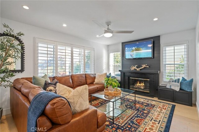 28332 Via Alfonse, Laguna Niguel, CA 92677 - living area with healthy amount of natural light, a ceiling fan, a glass covered fireplace, recessed lighting, and wood finished floors