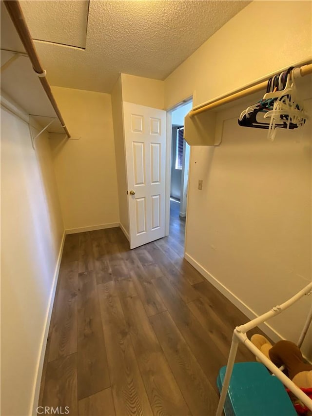 43321 Cottage Ln, Lancaster, CA 93536 - walk in closet with dark wood-style flooring