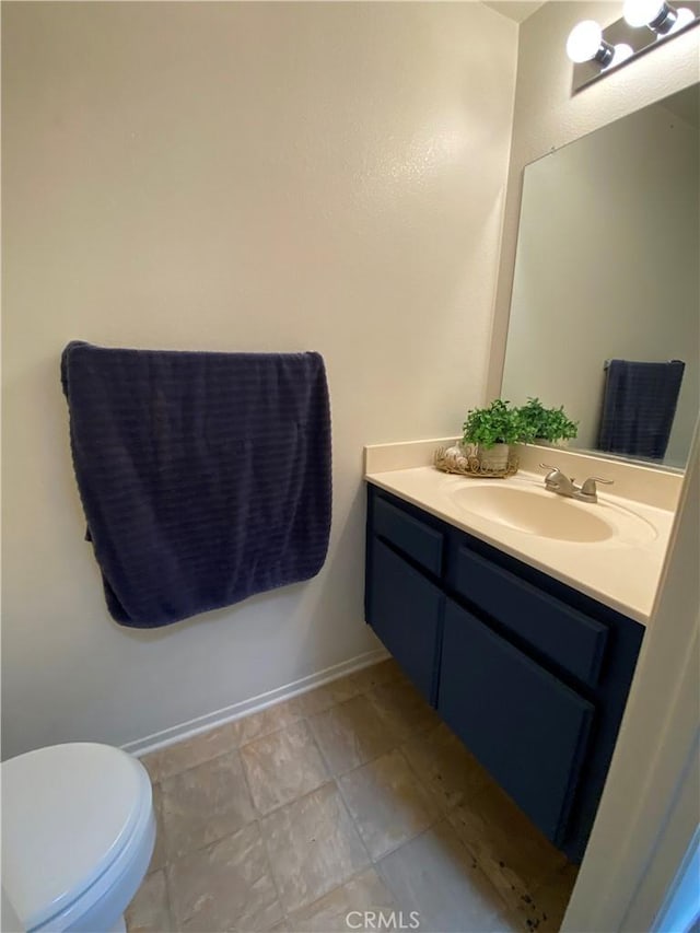 43321 Cottage Ln, Lancaster, CA 93536 - bathroom with vanity, toilet, and baseboards