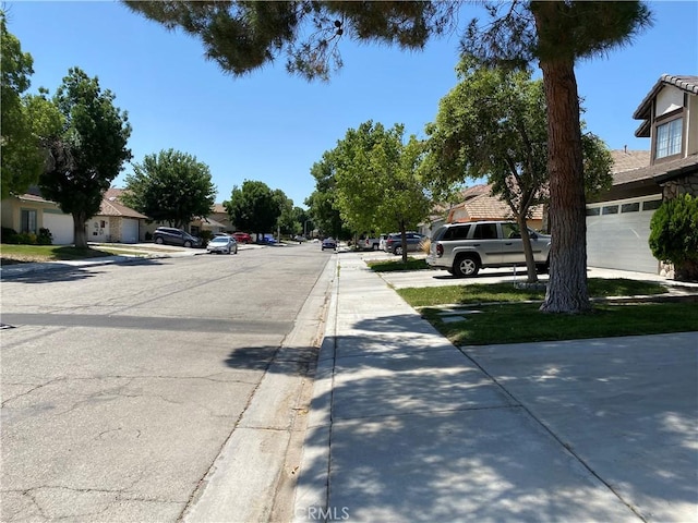43321 Cottage Ln, Lancaster, CA 93536 - view of asphalt street with sidewalks, curbs, and a residential view