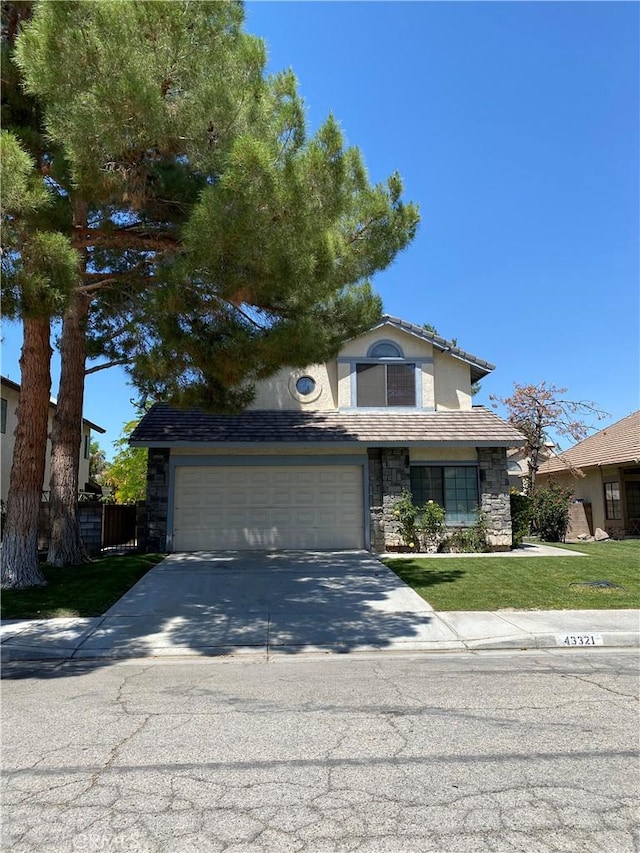 43321 Cottage Ln, Lancaster, CA 93536 - traditional home with stone siding, driveway, a garage, and stucco siding