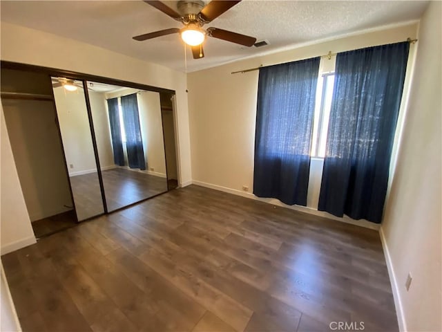 43321 Cottage Ln, Lancaster, CA 93536 - unfurnished bedroom with wood finished floors, a closet, and a ceiling fan