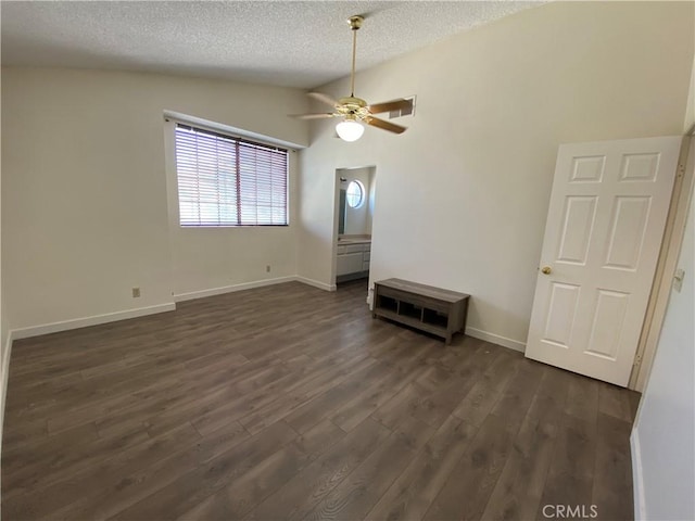 43321 Cottage Ln, Lancaster, CA 93536 - spare room featuring vaulted ceiling, a textured ceiling, dark wood-style floors, and ceiling fan