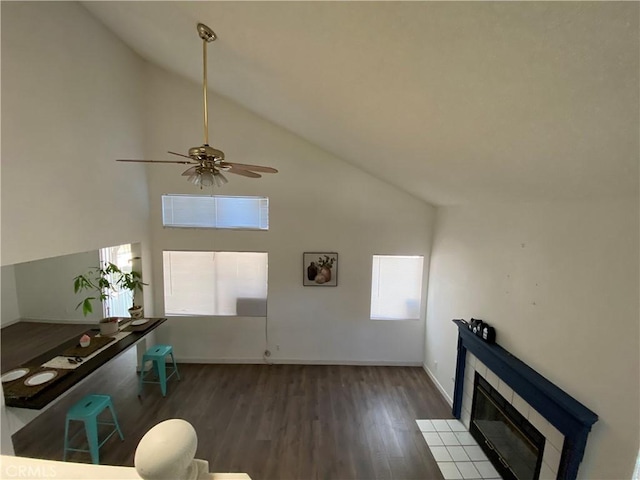 43321 Cottage Ln, Lancaster, CA 93536 - unfurnished living room featuring wood finished floors, high vaulted ceiling, plenty of natural light, a ceiling fan, and a fireplace