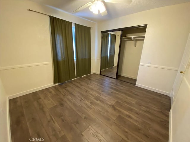 43321 Cottage Ln, Lancaster, CA 93536 - unfurnished bedroom with dark wood-style flooring, a closet, and a ceiling fan
