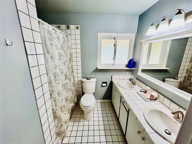 21161 Rancherias Rd, Apple Valley, CA 92307 - bathroom featuring toilet, double vanity, tile patterned flooring, and a shower with shower curtain