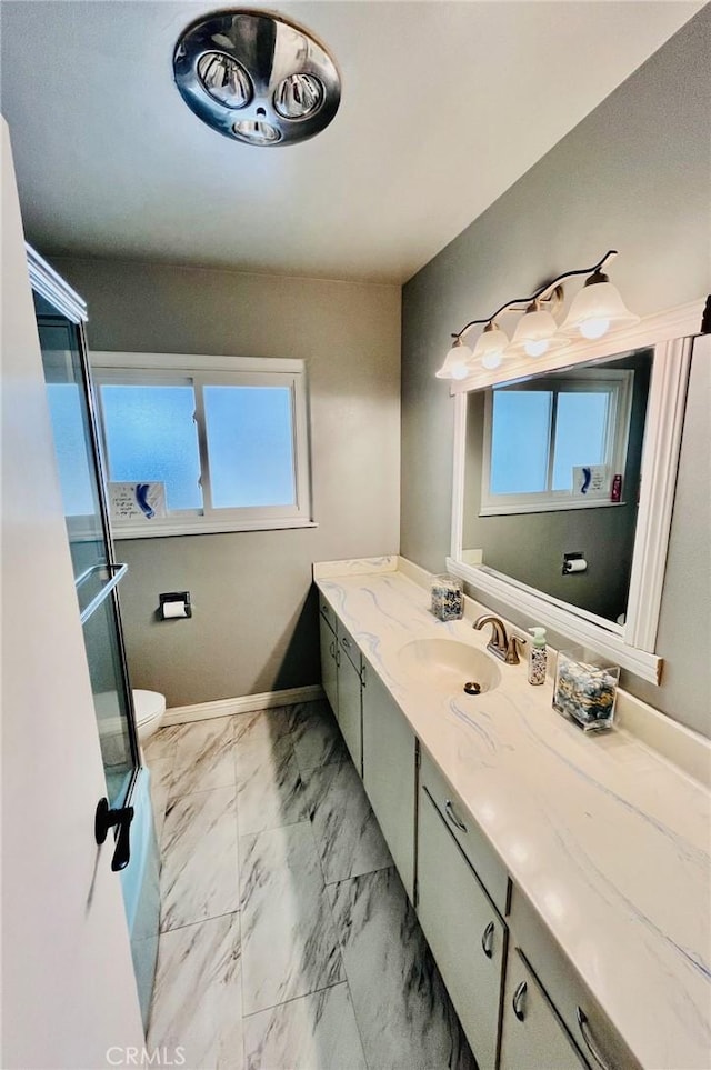 21161 Rancherias Rd, Apple Valley, CA 92307 - bathroom with toilet, vanity, healthy amount of natural light, and marble finish floors