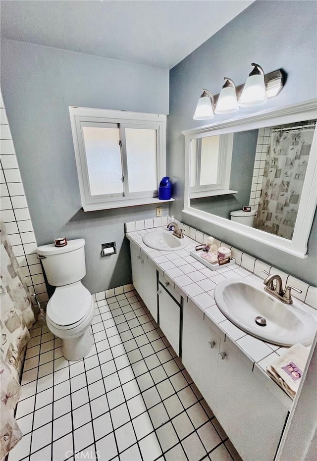 21161 Rancherias Rd, Apple Valley, CA 92307 - bathroom featuring toilet, double vanity, and tile patterned floors