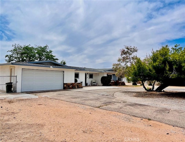 21161 Rancherias Rd, Apple Valley, CA 92307 - ranch-style house with driveway, a garage, and stucco siding