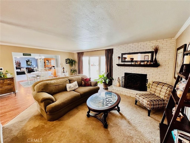 21161 Rancherias Rd, Apple Valley, CA 92307 - living room with crown molding, a fireplace, a textured ceiling, a chandelier, and wood finished floors