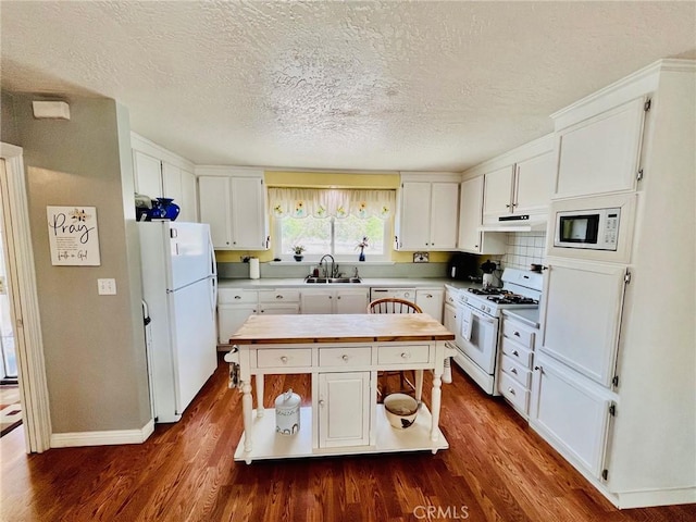21161 Rancherias Rd, Apple Valley, CA 92307 - kitchen with white appliances, a sink, white cabinetry, dark wood-type flooring, and a textured ceiling