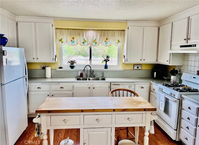 21161 Rancherias Rd, Apple Valley, CA 92307 - kitchen with white appliances, a sink, under cabinet range hood, wooden counters, and dark wood-style floors