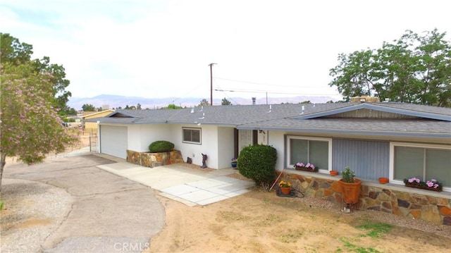 21161 Rancherias Rd, Apple Valley, CA 92307 - ranch-style house with a shingled roof, a garage, and driveway