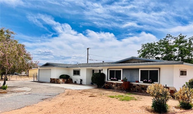 21161 Rancherias Rd, Apple Valley, CA 92307 - single story home featuring a garage, driveway, and stucco siding