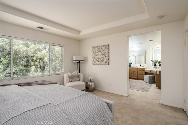 44035 Cindy Cir, Temecula, CA 92592 - bedroom featuring a tray ceiling, light carpet, and ensuite bath