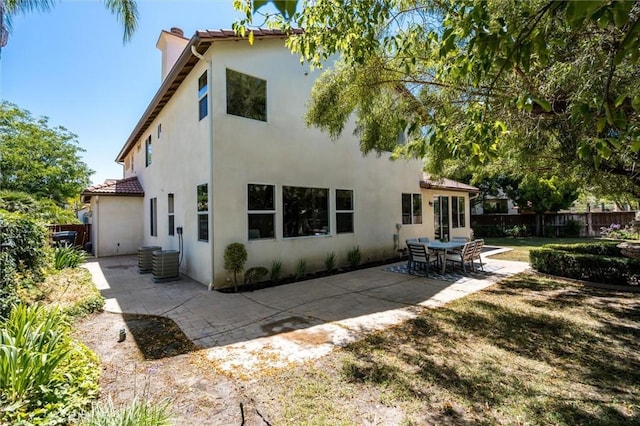 44035 Cindy Cir, Temecula, CA 92592 - back of house with a chimney, stucco siding, a patio, and a tile roof