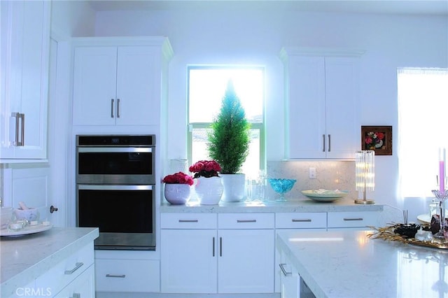 11986 Sagecrest Ct, Corona, CA 92883 - kitchen featuring stainless steel double oven, white cabinets, and healthy amount of natural light