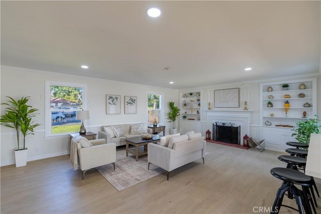 1748 Prince Albert Dr, Riverside, CA 92507 - living room featuring a fireplace with flush hearth, light wood finished floors, healthy amount of natural light, recessed lighting, and baseboards