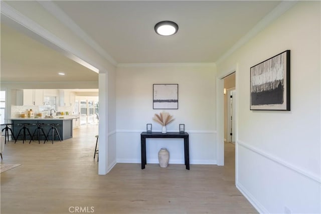 1748 Prince Albert Dr, Riverside, CA 92507 - corridor with light wood-type flooring, crown molding, a sink, and baseboards